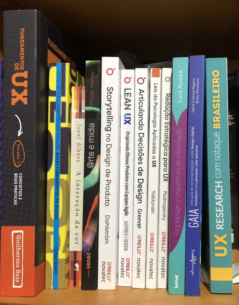 a shelf with 12 books about design and ux